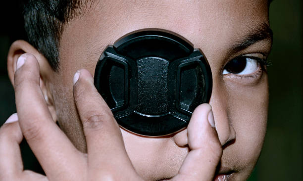 istock Indian child playing with lens cap 481369611