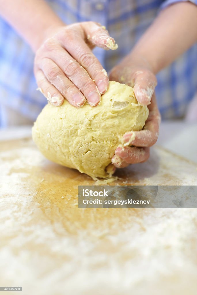 Kneading dough Cooking: woman hands kneading dough, close-up shot Adult Stock Photo