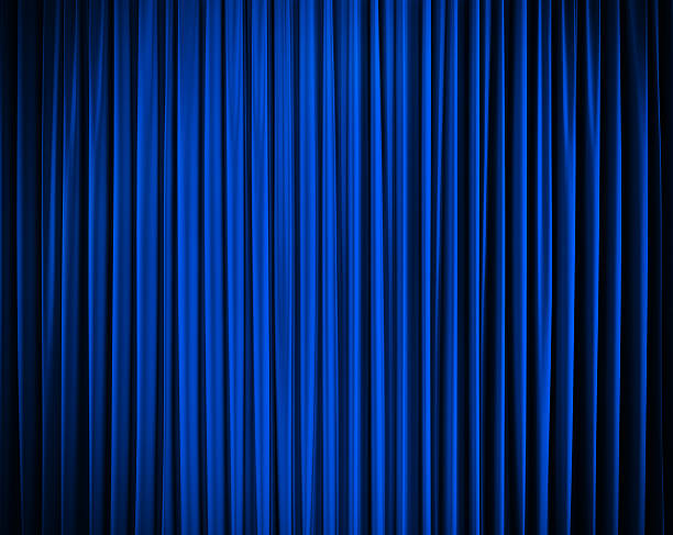 istock blue closed curtain with light spots in a theater 481370941