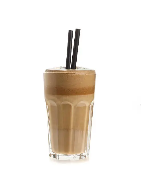 Glass of white coffee frappe isolated on white background