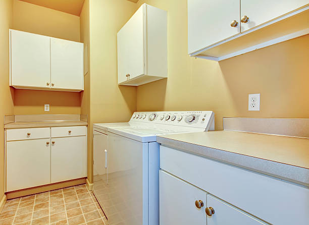 istock Laundry room with white cabinets and yellow walls. 481374715