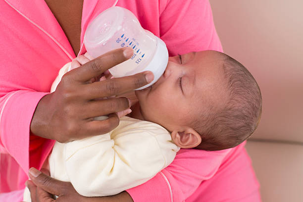 istock Month old baby drinking milk from a bottle. 481375471