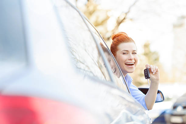istock woman inside car showing keys 481375609