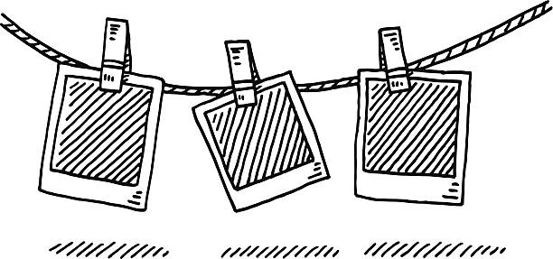 Laundry Line Blank Photographs Drawing Hand-drawn vector drawing of a Laundry Line and Blank Photographs. Black-and-White sketch on a transparent background (.eps-file). Included files are EPS (v10) and Hi-Res JPG. photos hanging string stock illustrations