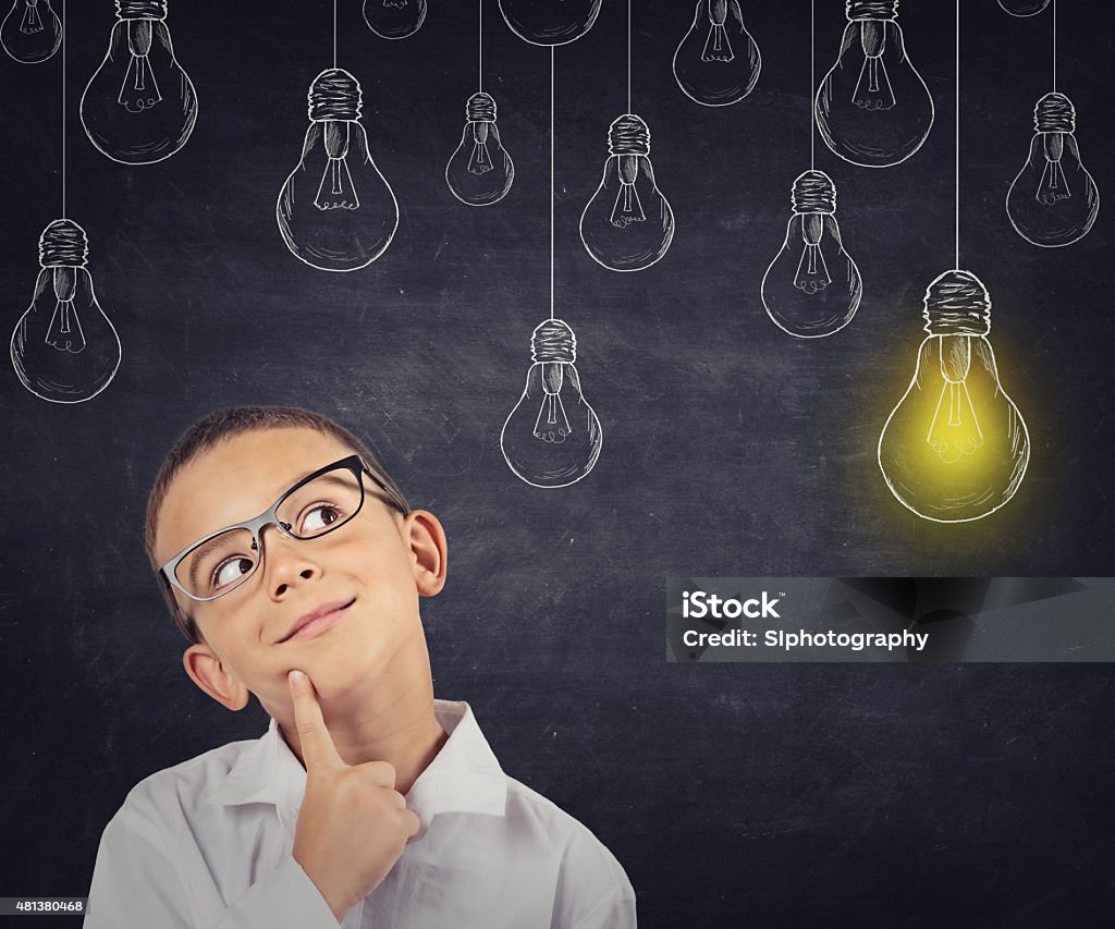 Big idea. Smart boy with solution lightbulb above head Big idea. Smart boy with solution lightbulb above head looking up Child Stock Photo