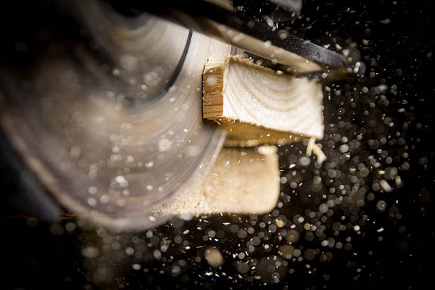 Carpenter with Circular Saw Close-up of carpenter cutting a wooden plank sawhorse stock pictures, royalty-free photos & images