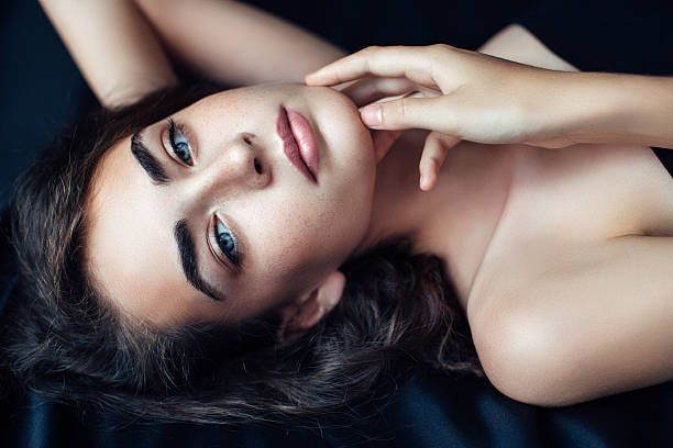 istock Young beautiful woman on dark background 481385934