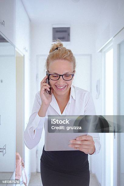 Young Woman Using A Digital Tablet And A Mobile Phone Stock Photo - Download Image Now