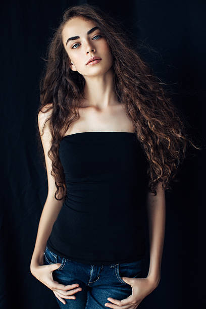 istock Young beautiful woman on dark background 481388064
