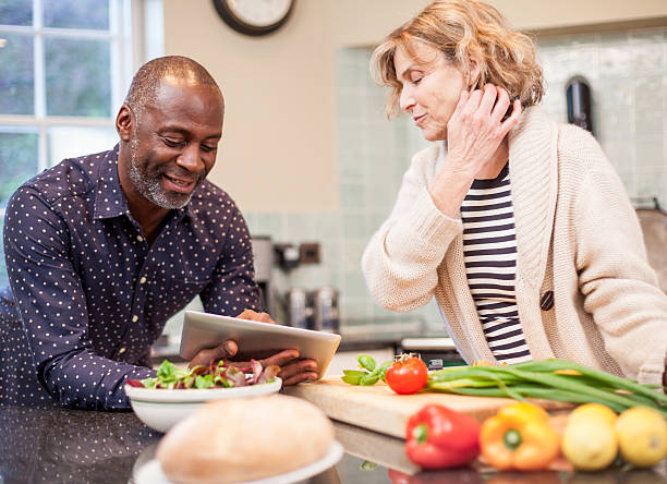 istock Multi-ethnic mature couple lookup recipe on tablet 481391411