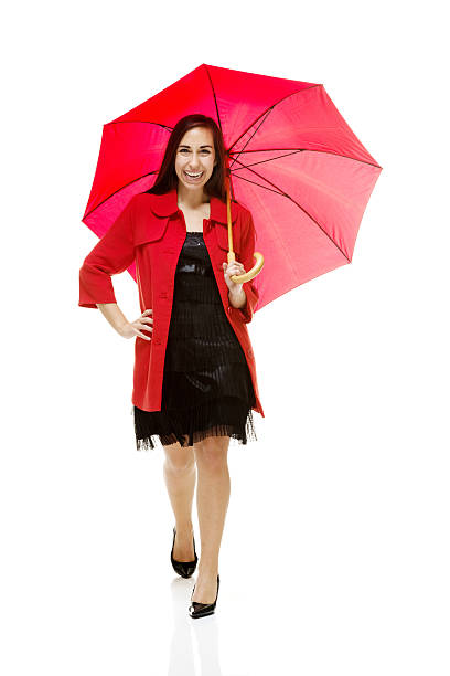 istock Smiling woman walking with umbrella 481391903