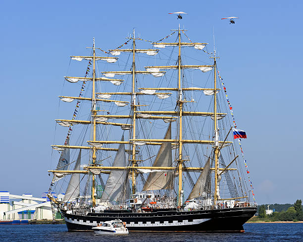 Barque Krusenstern, Riga - Latvia Riga, Latvia - July 28, 2013: The four-masted barque Kruzenshtern (or Krusenstern) runs along the river Daugava to be released in the Gulf of Riga Baltic Sea during the final parade of regatta sailing yacht "The Tall Ships Races 2013" krusenstern stock pictures, royalty-free photos & images