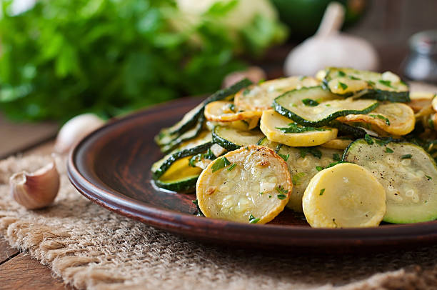 Warm salad with young zucchini with garlic and herbs Warm salad with young zucchini with garlic and herbs sauteed stock pictures, royalty-free photos & images