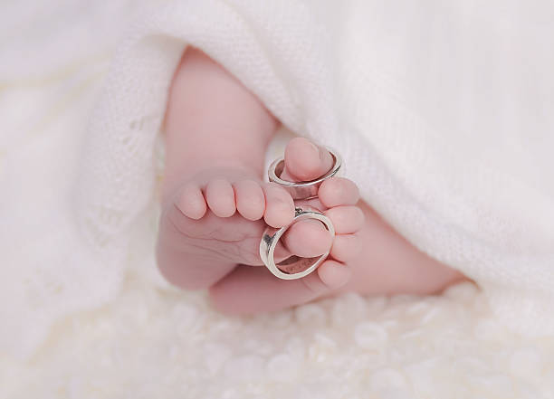 Parent holding baby hand