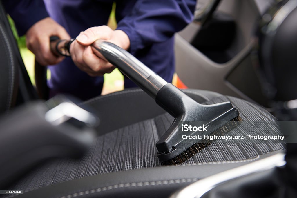 Man Hoovering Seat Of Car During Car Cleaning Car Stock Photo