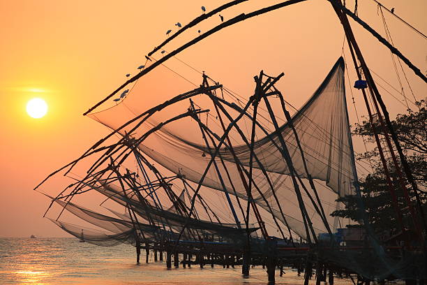 Chinese fishing nets, Cochin An image of the Chinese fishing nets of Cochin at sunset cochin kerala india chinese fishing net stock pictures, royalty-free photos & images
