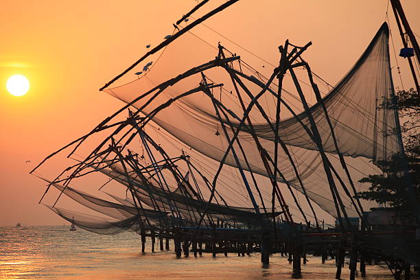 Chinese fishing nets, Cochin An image taken in Cochin of the Chinese fishing nets at sunset cochin kerala india chinese fishing net stock pictures, royalty-free photos & images