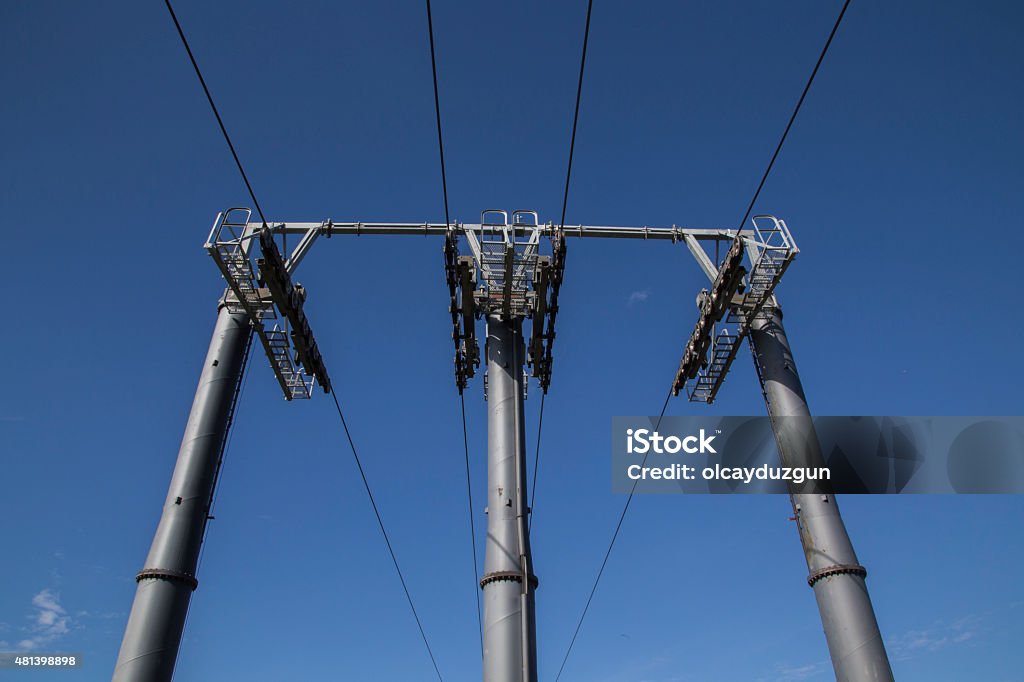 three poles with cables for cable car three  metal or steel poles and cables for cable car on air with blue clear sky 2015 Stock Photo