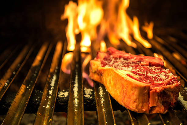 Ribeye steak grilled Ribeye Steak on Grill with Fire char grilled photos stock pictures, royalty-free photos & images