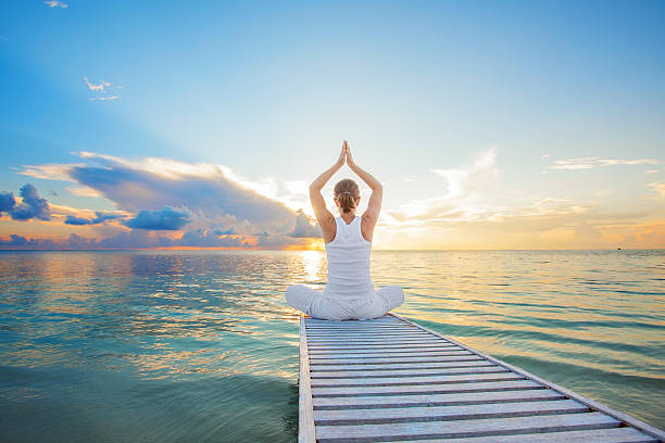 istock Caucasian woman practicing yoga at seashore 481401449