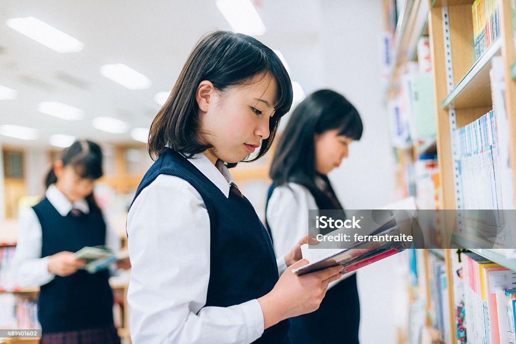 Japanese Female Students Reading in the Library Japanese Female Students reading in the School Library High School Student Stock Photo