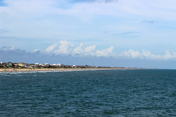 North Carolina Beach and Ocean Viewed from Water Emerald Isle Beach, beautiful sky, and blue water viewed from the water. Emerald Isle is a tourist town on the North Carolina coast. This area is also known as the Southern Outer Banks. emerald isle north carolina stock pictures, royalty-free photos & images