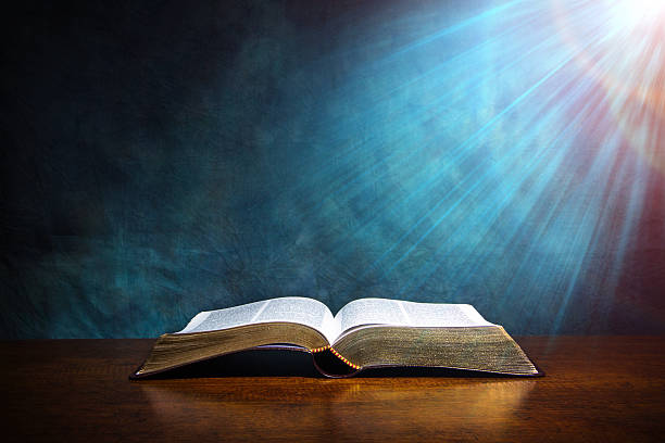 Open Bible Open Bible on a wood table with light coming from above. ( church concept ). baptist stock pictures, royalty-free photos & images