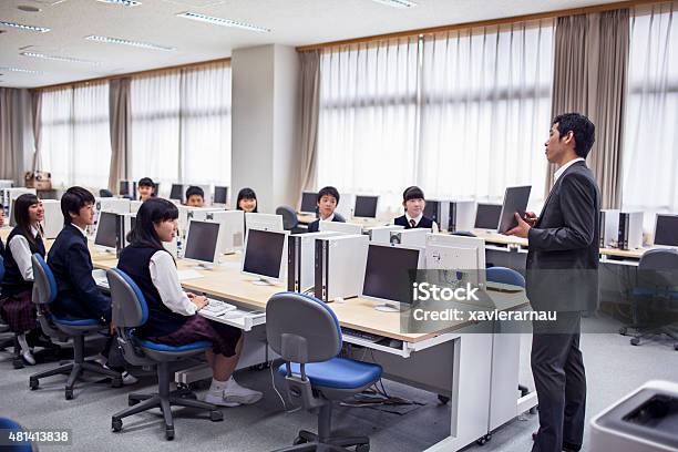 Japanese Teacher With His Students In The Computer Class Stock Photo - Download Image Now