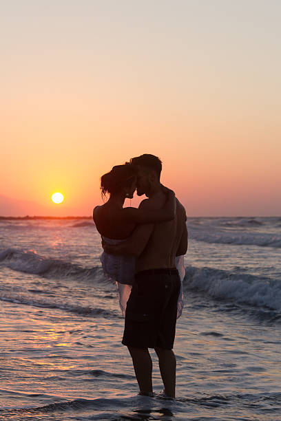istock Just married young couple on a hazy beach at dusk 481414134