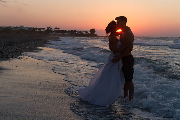 istock Just married young couple on a hazy beach at dusk 481414220