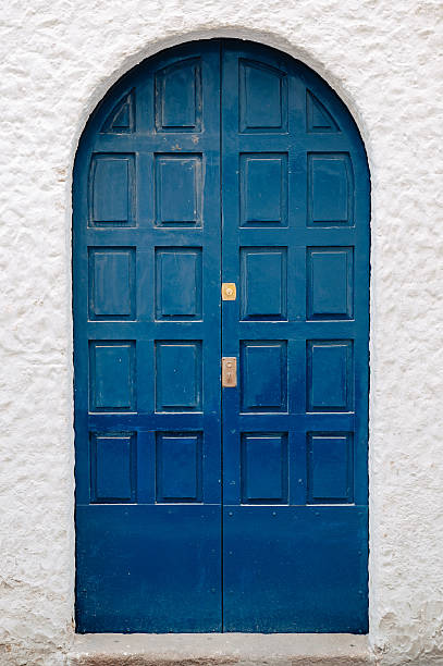 istock The blue door on a white wall 481416850