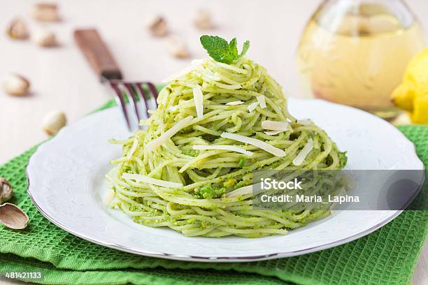 Italian Pasta Spaghetti With Pesto Green Peas Mint Pistachios Stock Photo - Download Image Now