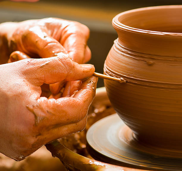 istock hands of a potter, creating an earthen jar 481422827