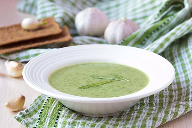 Green garlic cream soup with leaves rukola, arugula, healthy stock photo