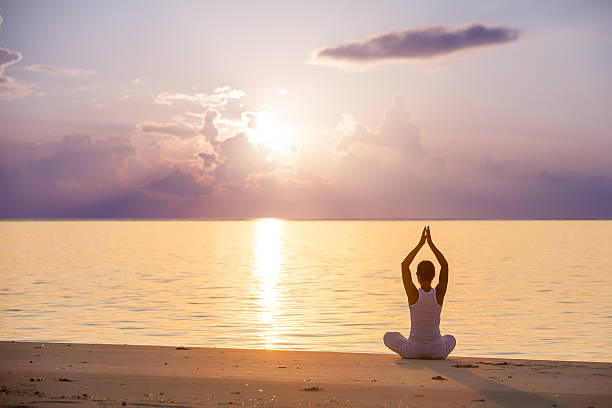 istock Caucasian woman practicing yoga at seashore 481424545