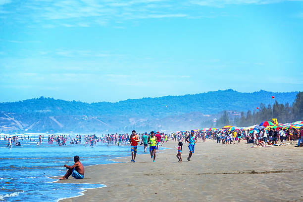 Busy Beach at Olon, Ecuador Olson, Ecuador - February 16, 2015: People on a busy beach during carnival in Olon, Ecuador on February 16, 2015 montanita ecuador stock pictures, royalty-free photos & images