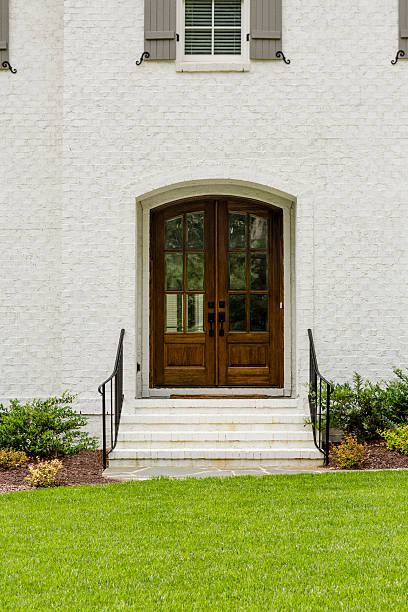 istock Dark wood door, with arches and a brick facade 481426086