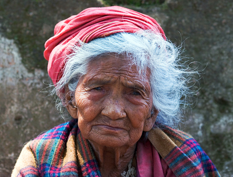Kathmandu, Nepal - May 10, 2008: Nepalese aged woman seeks alms on the street