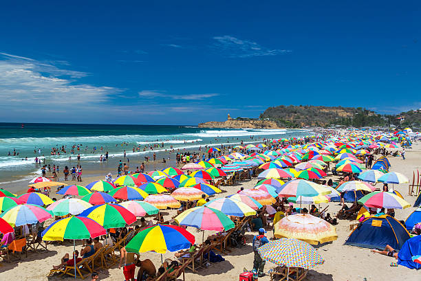 Packed Beach in Montanita, Ecuador Montanita, Ecuador - February 16, 2015: Colorful umbrellas packing a beach during carnival in Montanita, Ecuador on February 16, 2015 montanita ecuador stock pictures, royalty-free photos & images