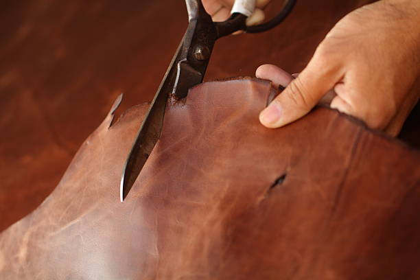 Old women's hands with cutting at textile factory