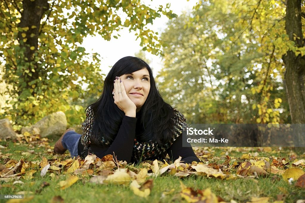 Autumn pretty woman lying on a meadow Adult Stock Photo