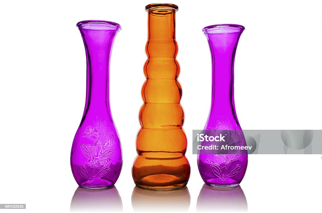 Three glass vases. Three colored glass vase close-up isolated on white background. Bottle Stock Photo