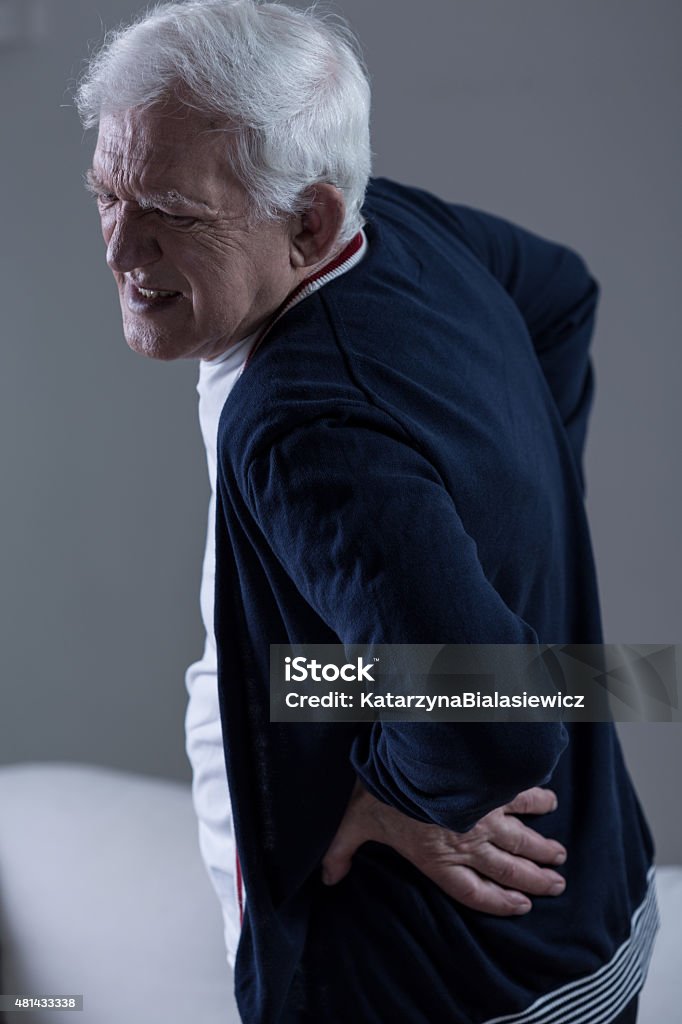 Old man backpain Old man with horrible backpain 2015 Stock Photo