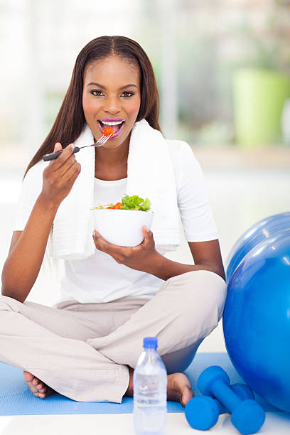 istock afro american woman eating salad 481434183