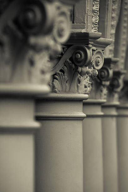 Five Columns A row of columns is shown with one being in focus. The photograph is edited in a muted monochromatic tone.  five columns stock pictures, royalty-free photos & images