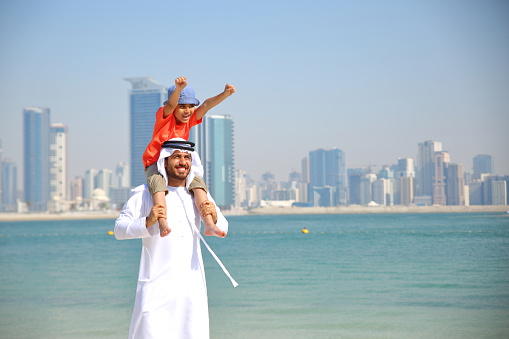 Arabian family playing in the beach.