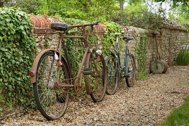 istock Two Bicycles Propped against a Countryside Wall 481444390
