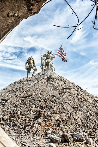 istock WWII US Army Infantry Squad Climbing Hill With American Flag 481447244