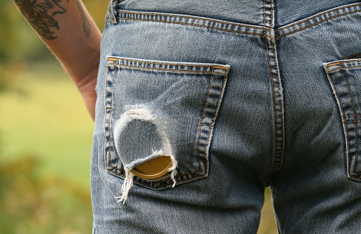 Man with can of chewing tobacco in his back pocket