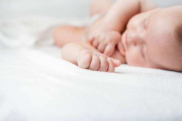 istock Newborn baby sweet sleeping on a white bed 481447674